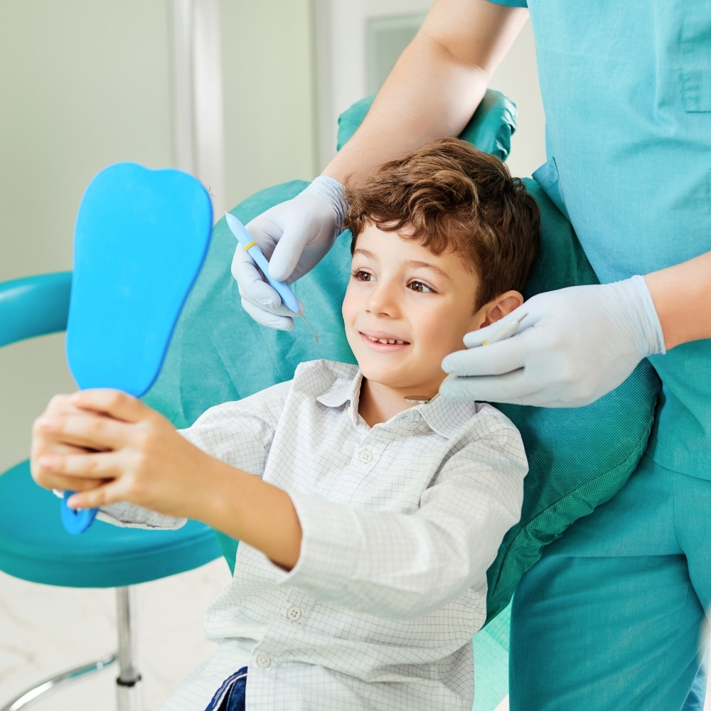 kid seeing his face in mirror after visiting pediatric dentist in scarborough, on